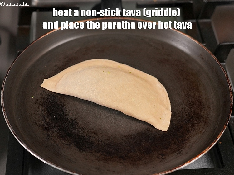Step 29 – Heat a non-stick tava (griddle) and place the paratha over hot tava.