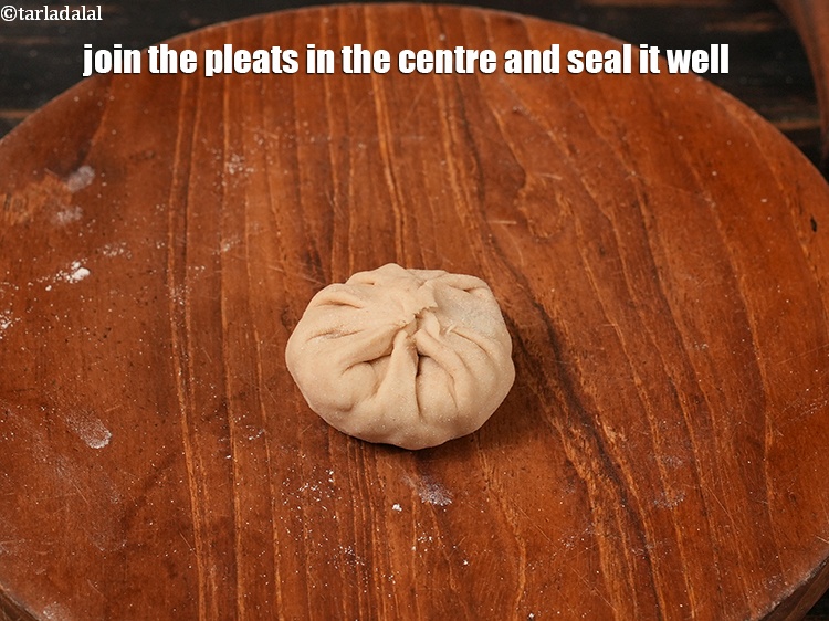 Step 30 – Join the pleats in the centre and seal it well.