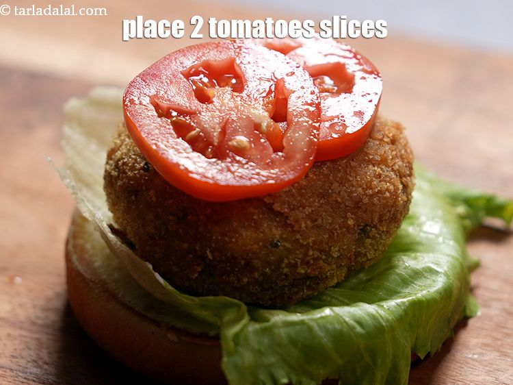 Step 36 – Place 2 <a href="https://www.tarladalal.com/glossary-tomatoes-tamatar-639i">tomatoes</a>&nbsp;slices.&nbsp;