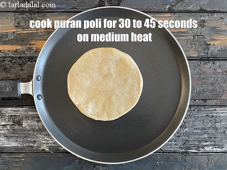 Step 30 – <meta charset="UTF-8" />Cook puran poli for 30 to 45 seconds on a medium flame.&nbsp;&nbsp;&nbsp;&nbsp;