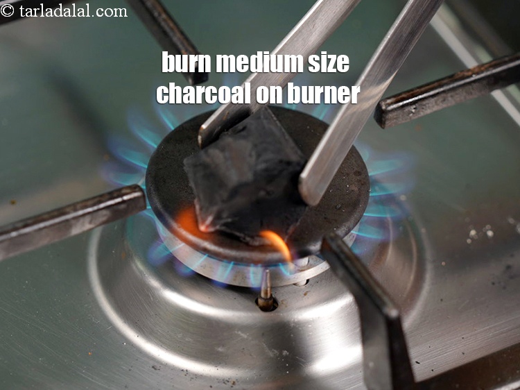 Step 30 – Burn a medium size of <a href="https://www.tarladalal.com/glossary-charcoal-1950i">charcoal</a> on the burner.