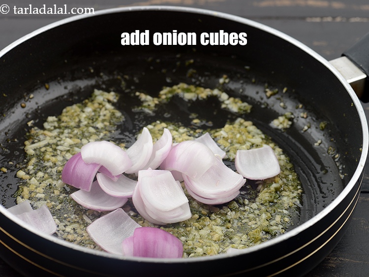 Step 31 – Add &frac12; cup <a href="https://www.tarladalal.com/glossary-onion-cubes-732i">onion cubes</a>.