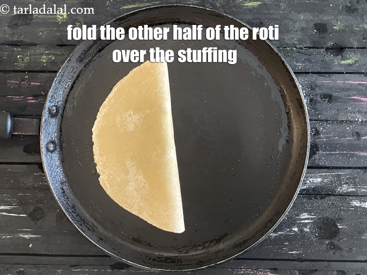 Step 32 – Fold the other half of the roti over the stuffing to make a semi-circle.