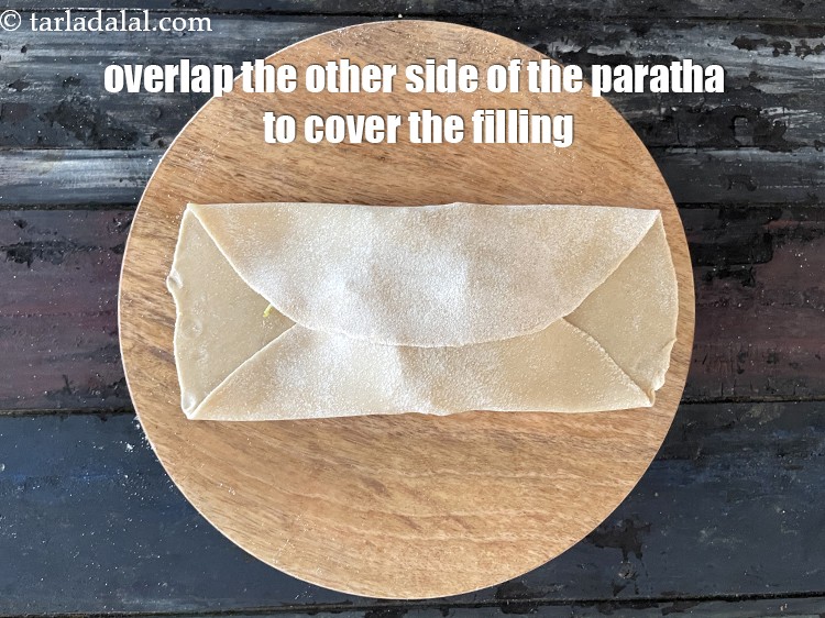 Step 32 – Then overlap the other side. We are making an envelope shaped paratha.