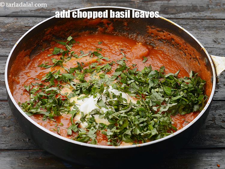 Step 31 – Add&nbsp;1/2 cup&nbsp;<a href="https://www.tarladalal.com/glossary-chopped-basil-804i">chopped basil leaves</a>.