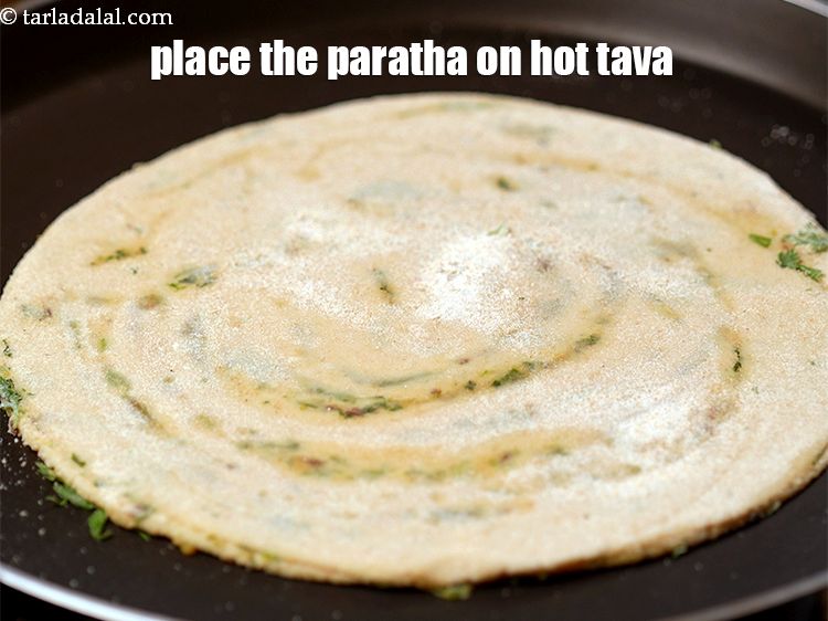 Step 30 – Heat a non-stick tava (griddle) and place the rolled paratha on hot tava.