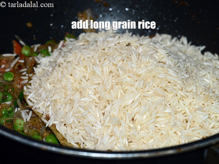 Step 30 – Add the washed and drained <a href="https://www.tarladalal.com/glossary-long-grain-rice-basmati-chawal-basmati-rice-535i">long grain rice (basmati chawal)</a>.