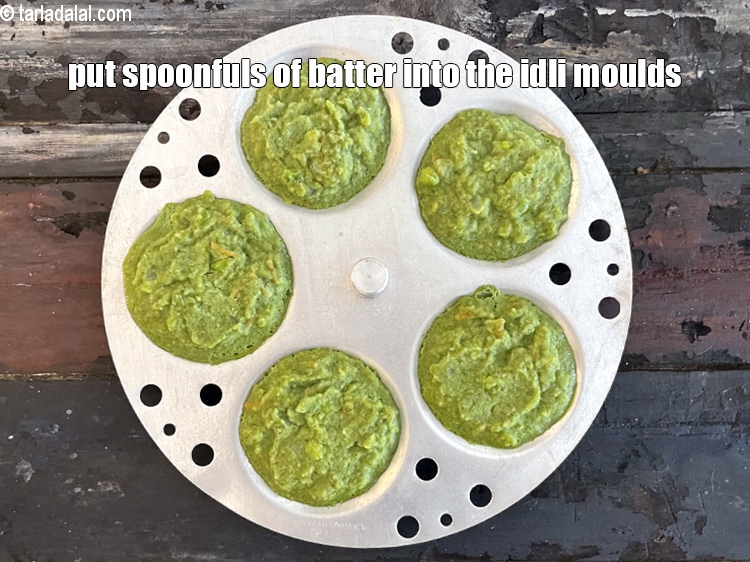 Step 30 – <meta charset="UTF-8" /> Put spoonfuls of the batter into greased idli moulds.&nbsp;