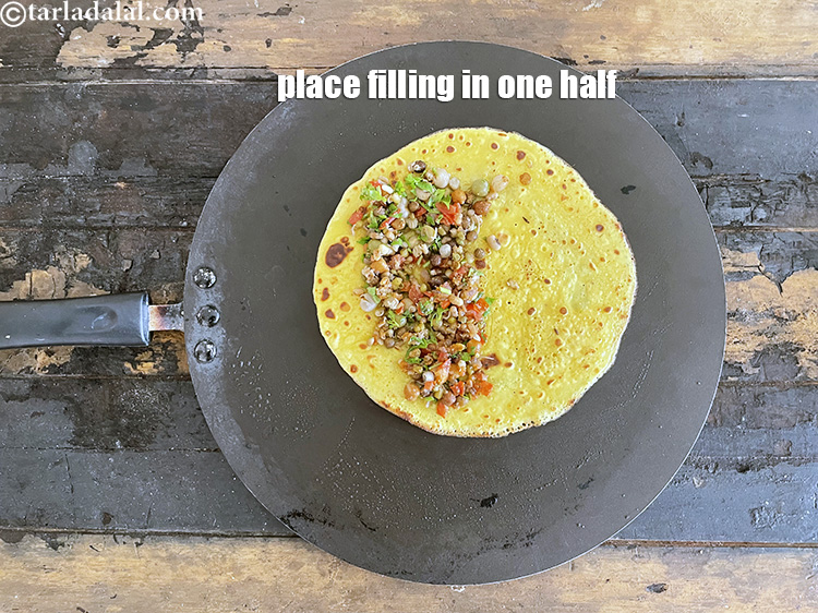 Step 47 – Place one portion of the stuffing on one half of the chilla.