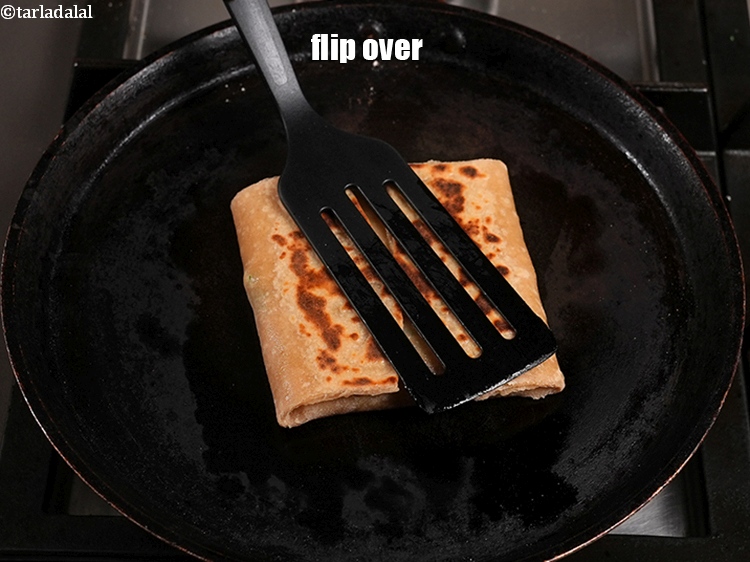 Step 51 – Grease the top of the paratha with little oil.