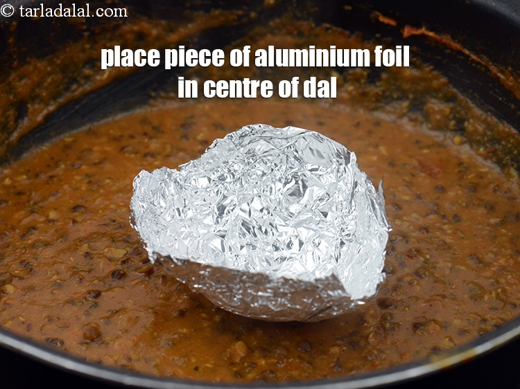 Step 31 – Place a piece of aluminium foil in the centre of the dal.