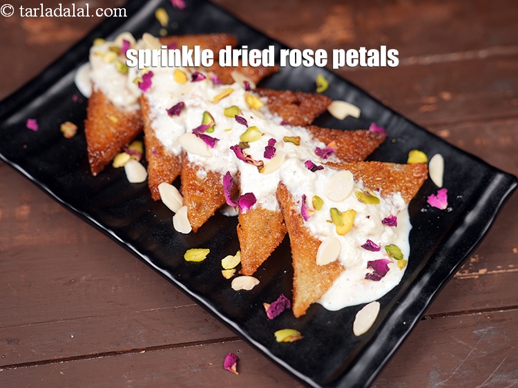 Step 32 – Sprinkle <a href="https://www.tarladalal.com/glossary-dried-rose-petals-2501i">dried rose petals</a>.