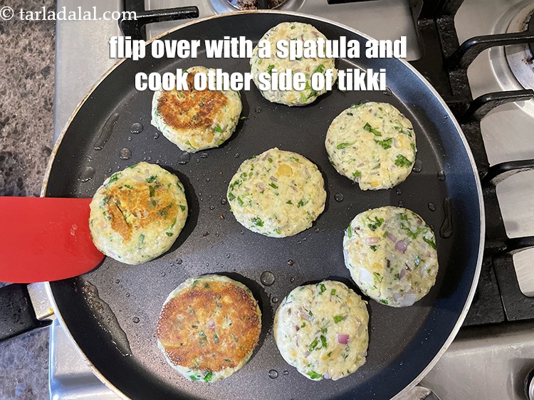 Step 32 – Flip over the tikkis with a spatula and cook the other side.