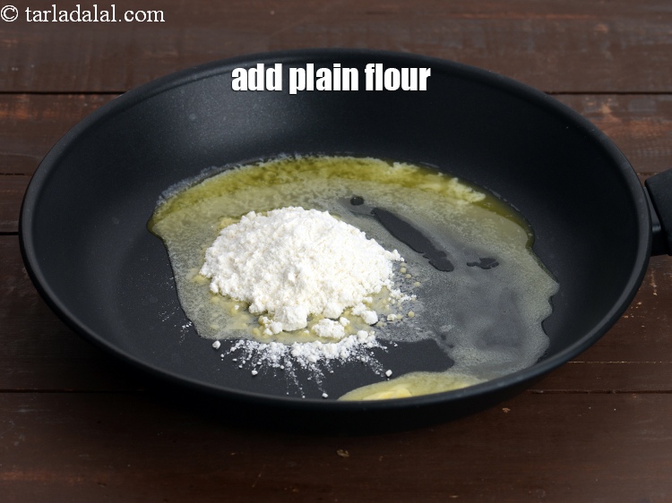 Step 33 – Add 2 tsp&nbsp;<a href="https://www.tarladalal.com/glossary-plain-flour-maida-188i">plain flour (maida)</a>.