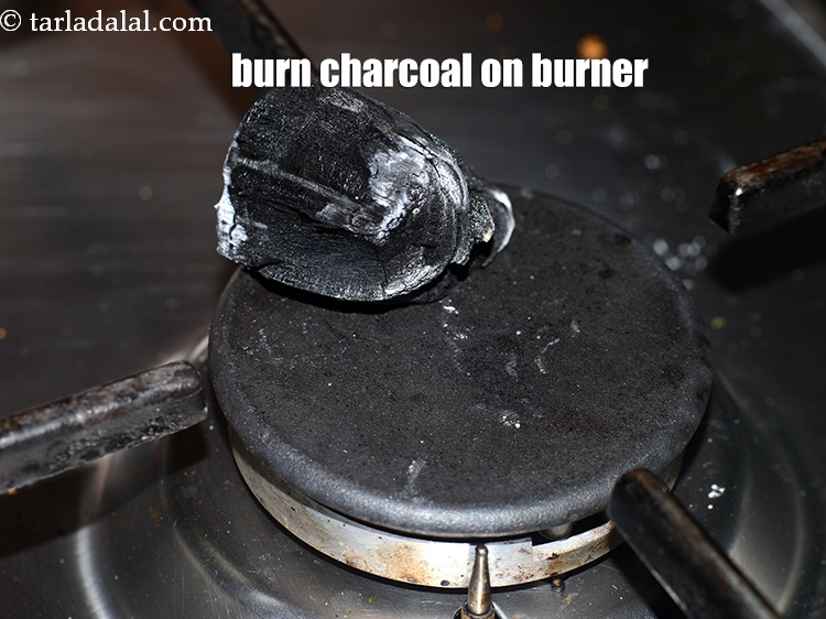 Step 31 – Burn a medium peice of &nbsp;<a href="https://www.tarladalal.com/glossary-charcoal-1950i">charcoal</a>&nbsp;on a burner.