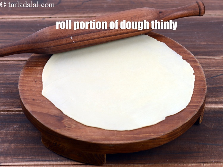 Step 33 – Roll a portion of the dough thin into a 225 mm. (9&rdquo;) diameter circle without …