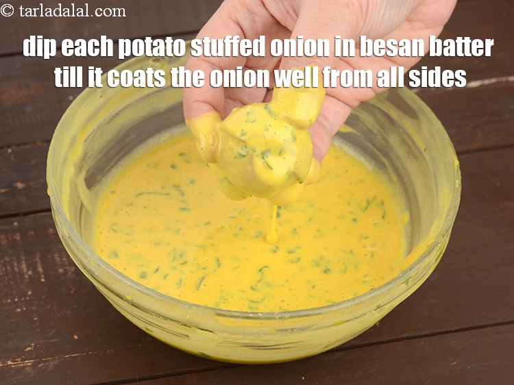 Step 34 – Dip each potato stuffed onion in besan batter till it coats the onion well from …
