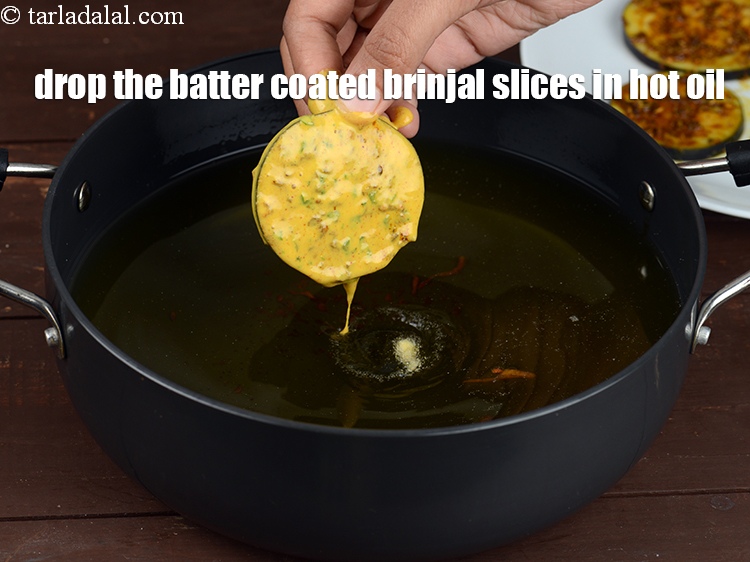 Step 32 – Drop the batter coated brinjal slices in hot oil.&nbsp;