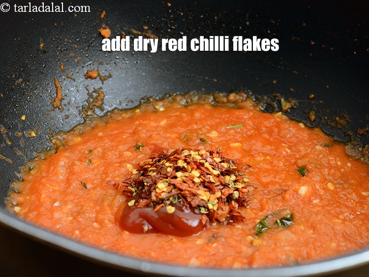 Step 33 – Add 1 tsp <a href="https://www.tarladalal.com/glossary-dry-red-chilli-flakes-paprika-338i">dry red chilli flakes (paprika)</a>.