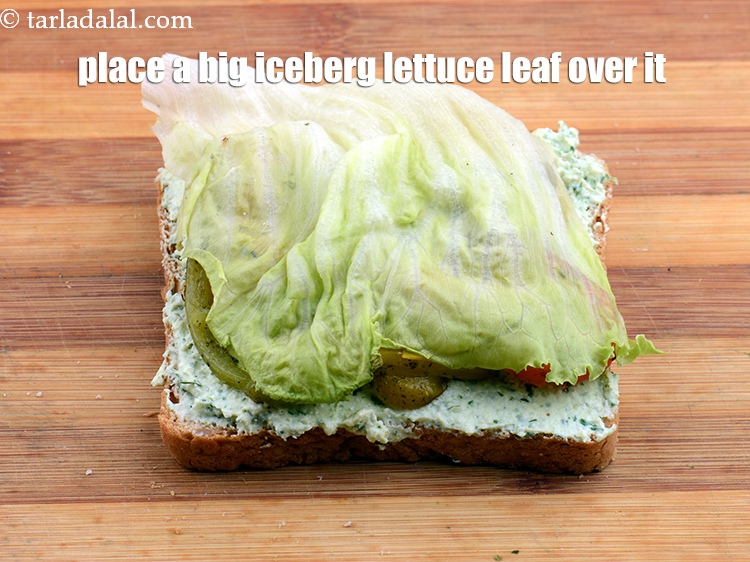 Step 31 – Place a big&nbsp;<a href="https://www.tarladalal.com/glossary-iceberg-lettuce-iceberg-salad-ke-patte-499i">iceberg lettuce lea</a>f&nbsp;over it.