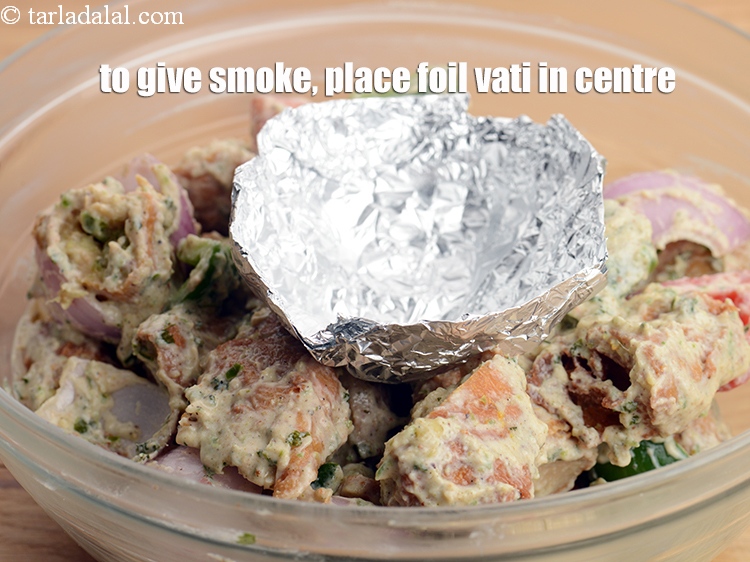 Step 34 – Now to give smoke, place an aluminium foil vati in the centre of the marination.