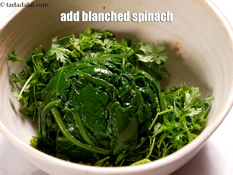 Step 4 – Add &frac12; cup <a href="https://www.tarladalal.com/glossary-blanched-spinach-727i">blanched spinach (palak)</a>.