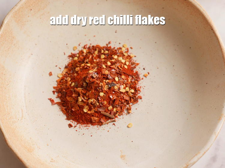 Step 4 – Add 2 tsp <a href="https://www.tarladalal.com/glossary-dry-red-chilli-flakes-paprika-338i">dry red chilli flakes (paprika)</a>.