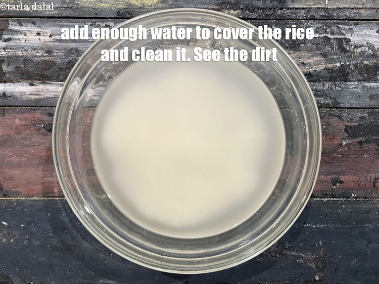 Step 4 – Add enough water to cover the rice. &nbsp;Clean the rice. You can see the dirt.