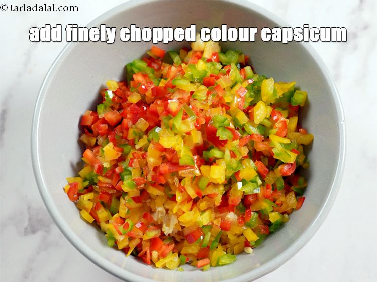 Step 5 – Add &frac34; cup finely&nbsp;<a href="https://www.tarladalal.com/glossary-chopped-coloured-capsicum-2800i">chopped coloured capsicum</a>.