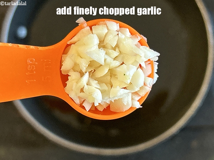 Step 11 – Add&nbsp;<strong>1 1/2 tsp</strong> &nbsp;finely&nbsp;<a href="glossary-chopped-garlic-790i">chopped garlic (lehsun)</a>.<br /> &nbsp;