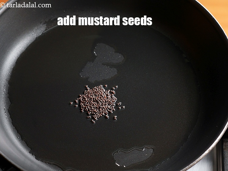 Step 5 – Add &frac12; tsp <a href="https://www.tarladalal.com/glossary-mustard-seeds-sarson-rai-sarson-ke-beej-525i">mustard seeds ( rai / sarson)</a>.