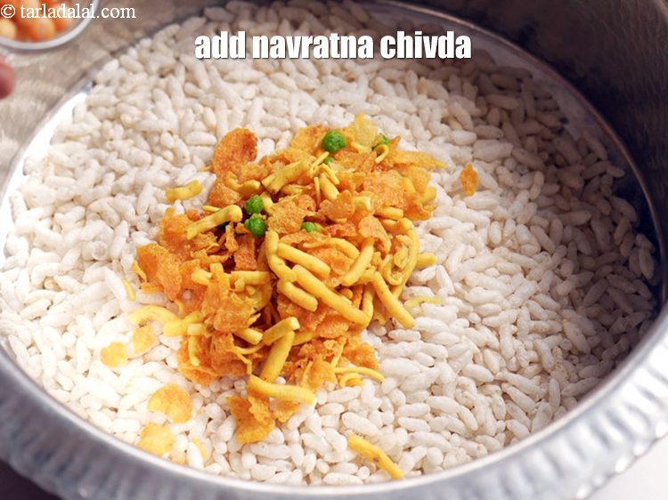 Step 5 – Add 1 cup <a href="https://www.tarladalal.com/glossary-navratna-chivda-2810i">navratna chivda</a>.
