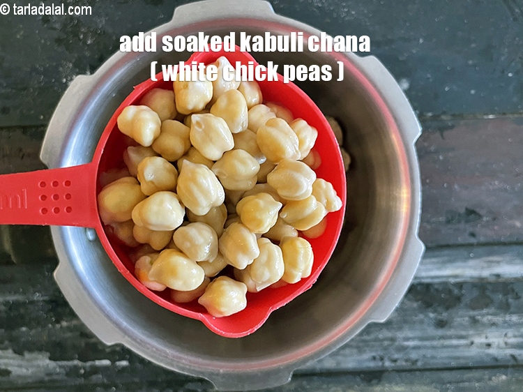 Step 14 – Add&nbsp;<meta charset="UTF-8" />1 cup&nbsp;<a href="glossary-soaked-kabuli-chana-291i">soaked kabuli chana (white chick peas)</a>.