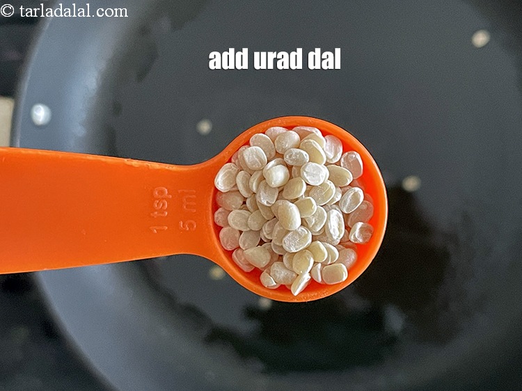 Step 47 – Add&nbsp;<meta charset="UTF-8" />1 tsp&nbsp;<a href="glossary-urad-dal-split-black-lentil-941i">urad dal (split black lentils)</a>.