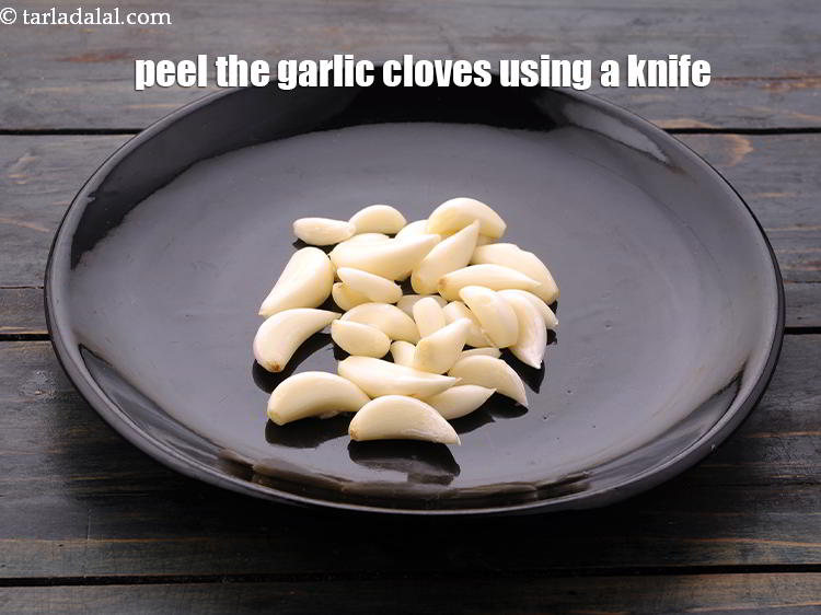 Step 3 – Peel the garlic cloves using a knife and discard the peel.