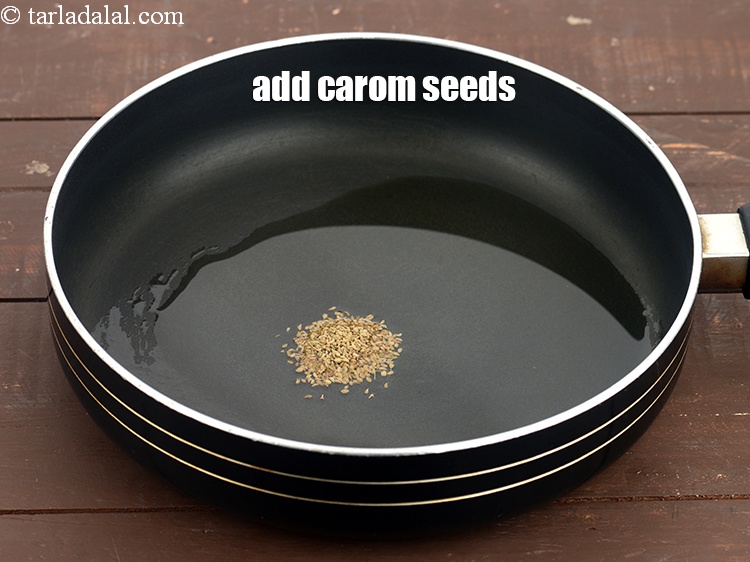 Step 10 – Add the carom 1/2 tsp&nbsp;<a href="https://www.tarladalal.com/glossary-carom-seeds-ajwain-thymol-seeds-bishops-weed-266i">carom seeds (ajwain)</a>&nbsp;and allow them to crackle.
