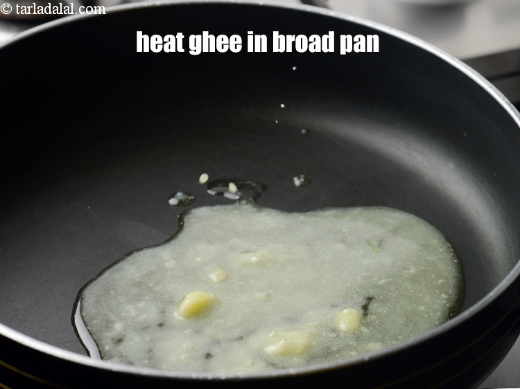 Step 6 – Heat 2 tbsp <a href="https://www.tarladalal.com/glossary-ghee-245i">ghee</a> in a broad non-stick pan.