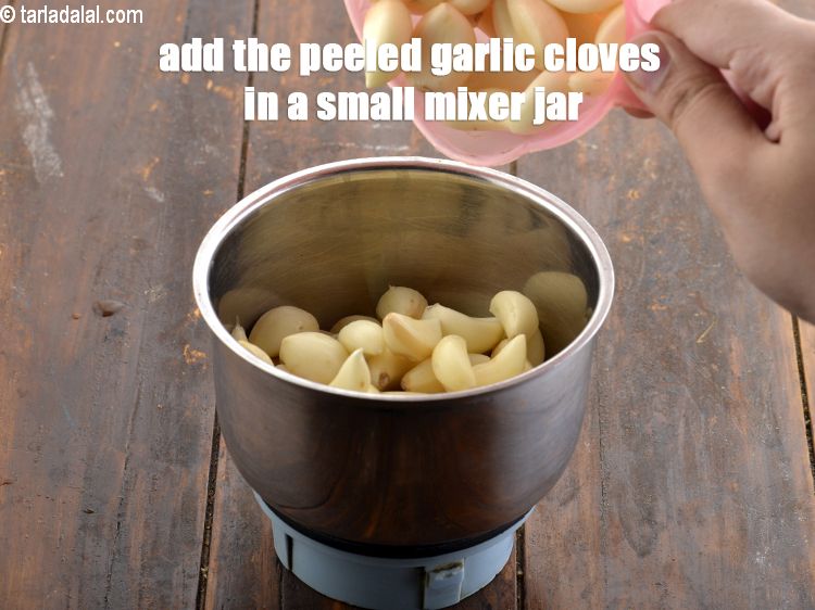 Step 4 – <meta charset="UTF-8" />Add the peeled garlic cloves in a small mixer jar.&nbsp;<br /> &nbsp;