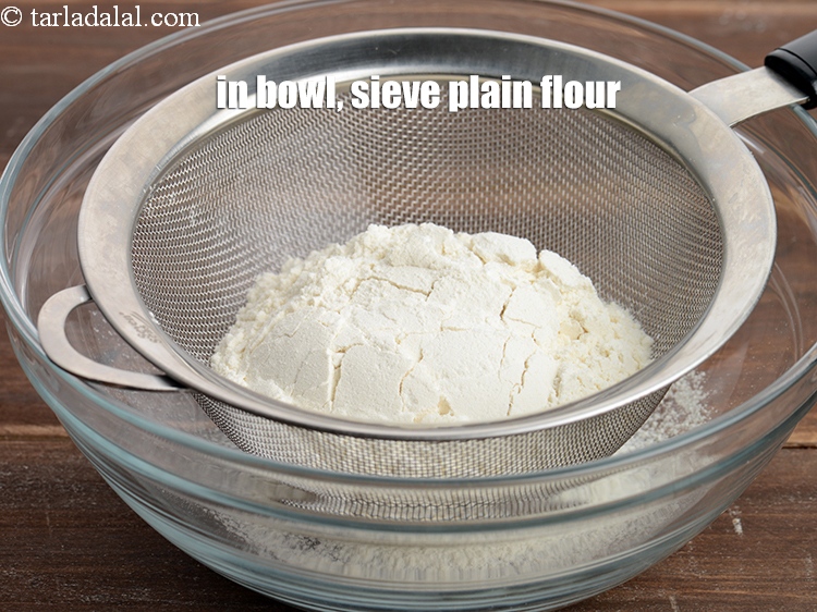 Step 4 – In a deep bowl, sieve &frac34; cup <a href="https://www.tarladalal.com/glossary-plain-flour-maida-188i">plain flour (maida)</a>.