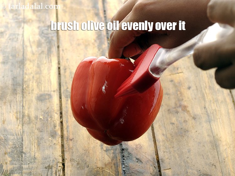 Step 4 – Brush <a href="https://www.tarladalal.com/glossary-olive-oil-451i">olive oil</a> evenly over it using a brush.