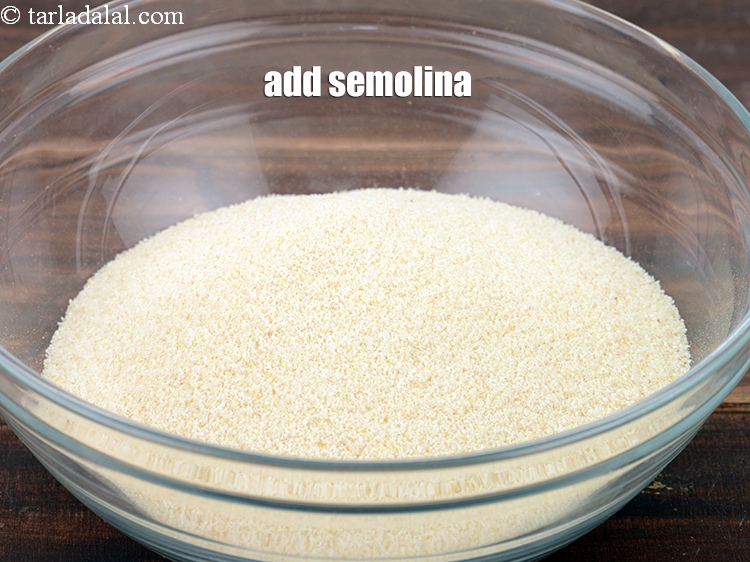Step 4 – Add &frac12; cup <a href="https://www.tarladalal.com/glossary-semolina-sooji-rava-rawa-603i">semolina (rava / sooji)</a>.