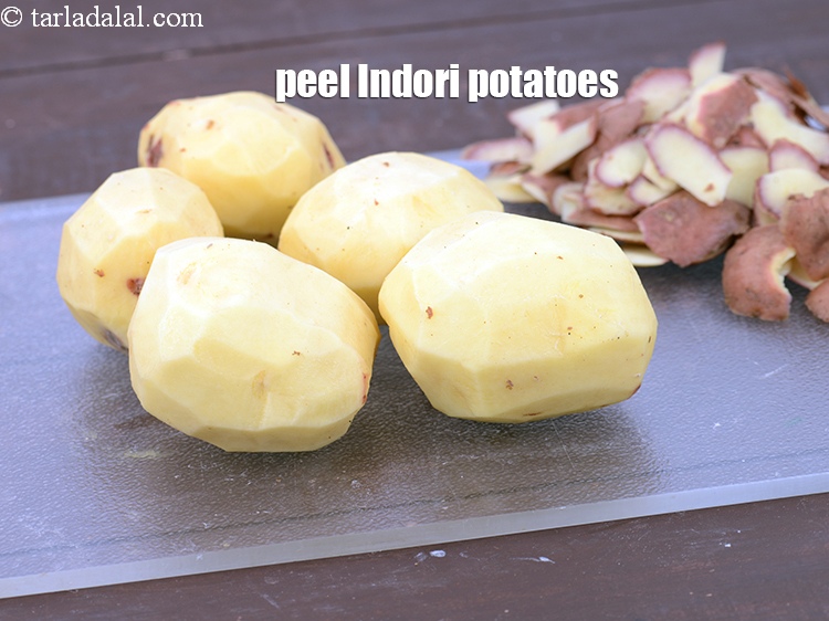 Step 6 – Peel 5&nbsp;big&nbsp;<a href="https://www.tarladalal.com/glossary-indori-potatoes-2808i">indori potatoes</a>. Discard the peels. &nbsp;