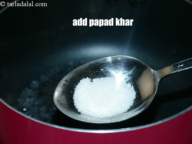 Step 5 – Add &frac12; tsp&nbsp;<a href="https://www.tarladalal.com/glossary-papad-khar-papad-kharo-alkaline-salt-powder-565i">papad khar</a>.&nbsp;