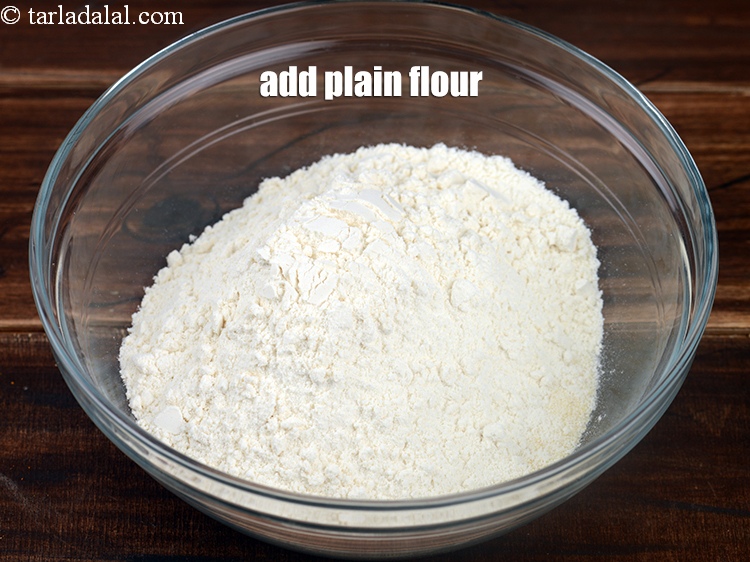 Step 7 – Add 1 cup <a href="https://www.tarladalal.com/glossary-plain-flour-maida-188i">plain flour (maida)</a>.