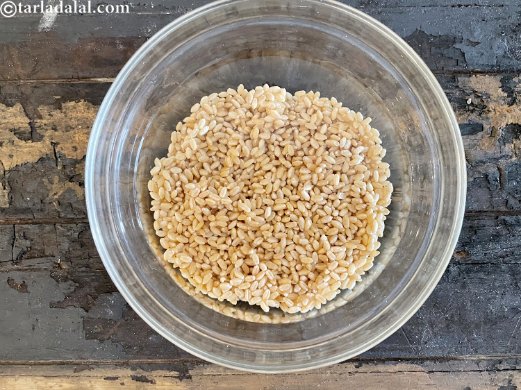 Step 6 – Put whole wheat in a deep glass bowl of water and clean the whole wheat …