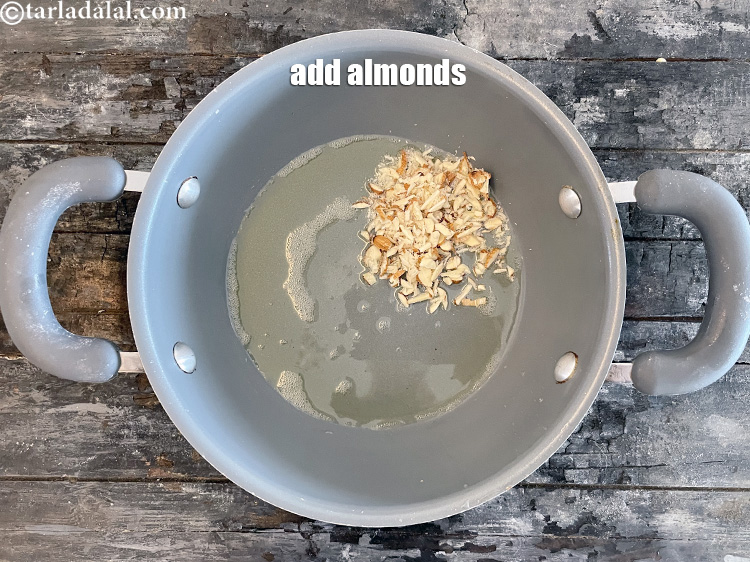 स्टेप 6 – २ टेबल-स्पून कटे हुए बादाम डालें।