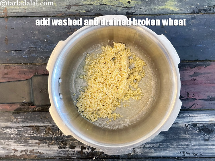 Step 9 – <meta charset="UTF-8" />Add 1/4 cup&nbsp;<a href="glossary-broken-wheat-dalia-bulgur-wheat-lapsi-fada-426i">broken wheat (dalia)</a>&nbsp;, washed and drained.