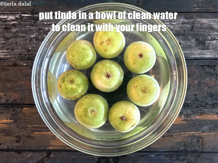 Step 4 – Put tinda ( round gourd) in a bowl full of water and clean with your …