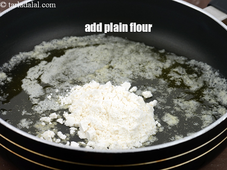 Step 4 – Add 2 1/2 tbsp&nbsp;<a href="https://www.tarladalal.com/glossary-plain-flour-maida-188i">plain flour (maida)</a>.