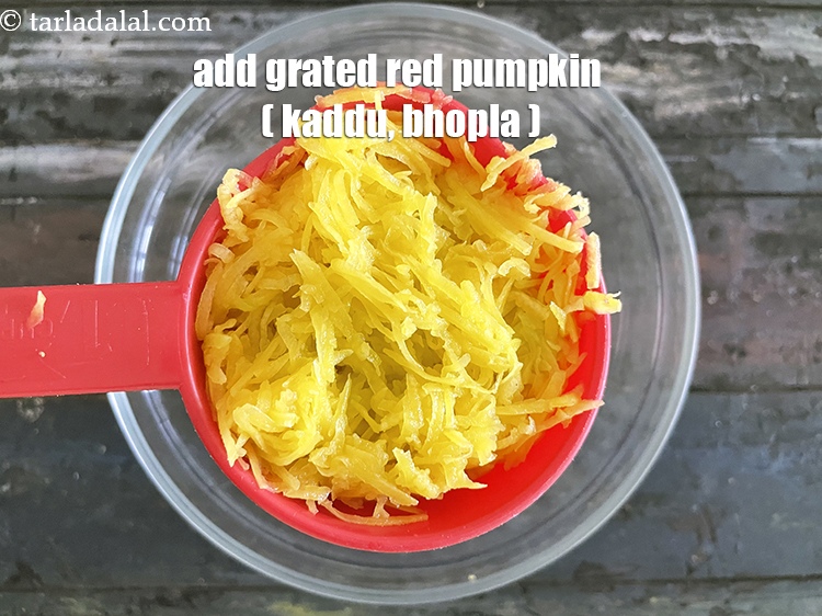 Step 7 – Add&nbsp;<meta charset="UTF-8" />1 cup&nbsp;<a href="glossary-grated-red-pumpkin-1084i">grated red pumpkin (kaddu/bhopla)</a>.